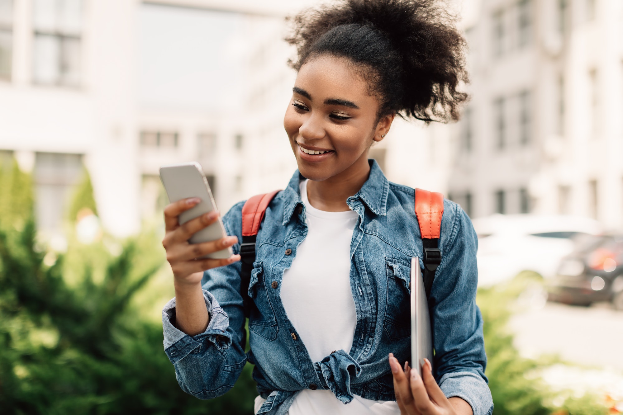 Happy Black College Girl Using Smartphone Texting Outdoor